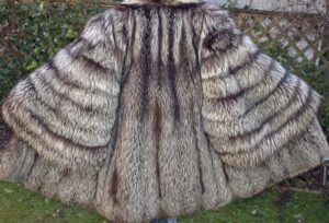 oman in a casual faux fur coat paired with black jeans and ankle boots.